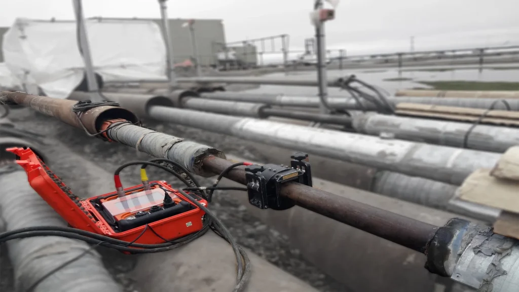 Guided Ultrasonics Wavemaker equipment performing guided wave inspection of overhead pipelines using non-invasive scanning technology.