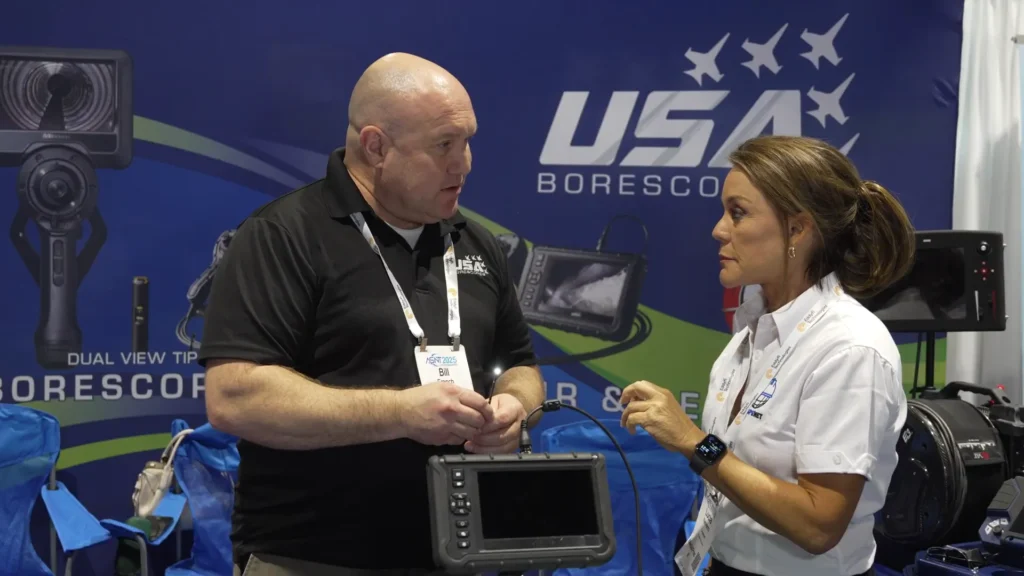 Bill French, sales specialist for USA Borescopes, demonstrates the operation of a borescope during an interview at ASNT 2025.
