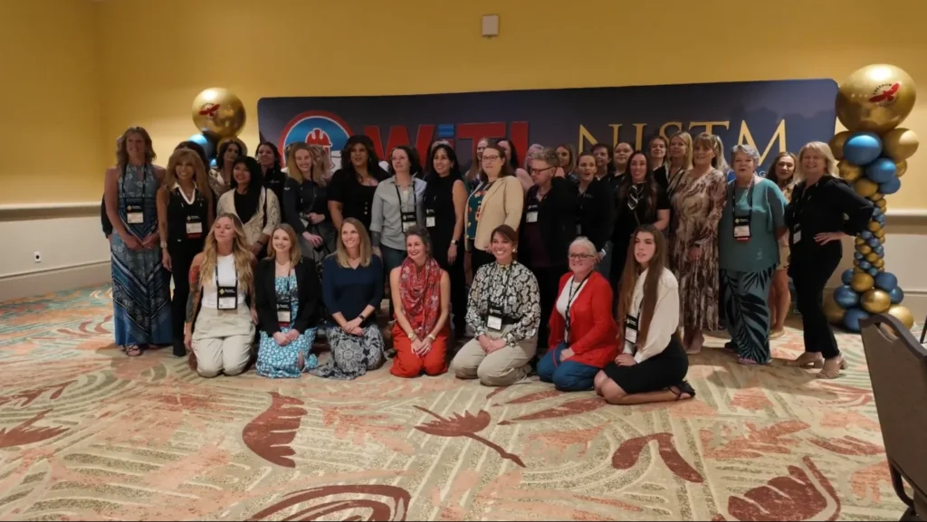 Group of women WiTi participants during NISTM 2026 in Orlando posing at a tank industry networking event.