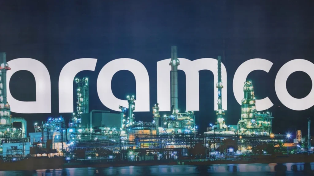Oleoducto y planta industrial de Aramco iluminada durante la noche en Arabia Saudita.