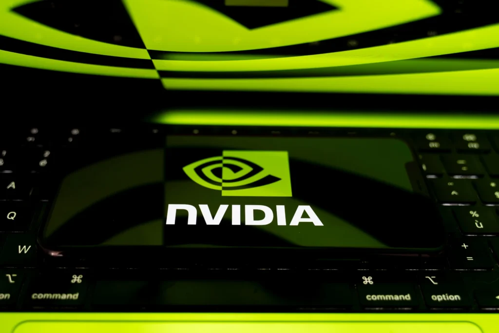 Nvidia logo displayed on a device resting on a keyboard with green lighting.