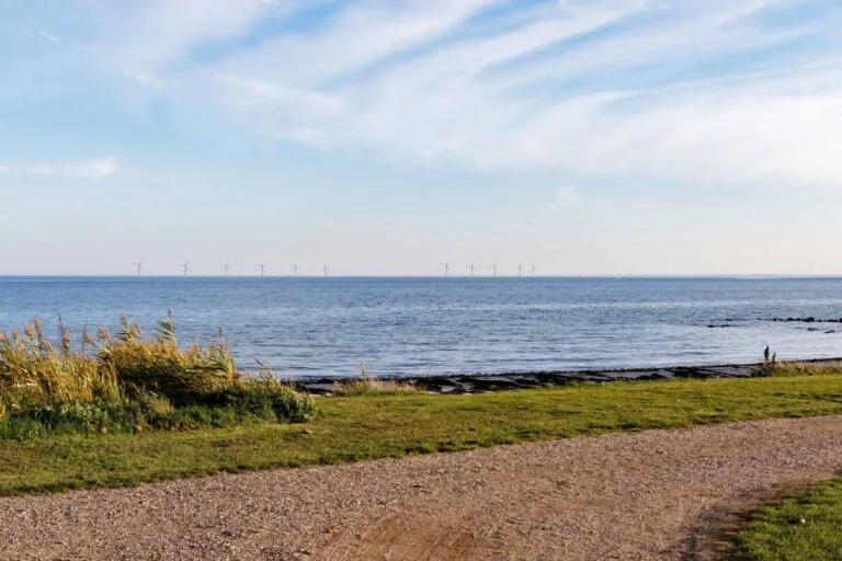 Lillebælt Syd, an offshore wind project off the Danish coast with wind turbines on the horizon.